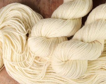 May include: A skein of off-white yarn, showing the texture and twist of the yarn.