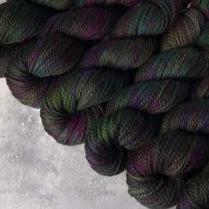 Aran pure British wool superwash hand-dyed knitting yarn 100g - ‘Space Race' dark grey flecks purple, green and blue BFL bluefaced Leicester