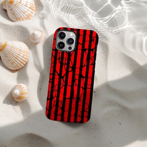 May include: A red and black striped phone case with a unique pattern. The case is lying on a bed of white sand, surrounded by seashells. The case has a glossy finish and a modern design.