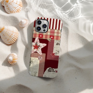 May include: A phone case with a patchwork design in red, white, and beige. The case features a star, hearts, and newspaper clippings. The top has red and white stripes. Seashells are in the background, creating a beach theme.
