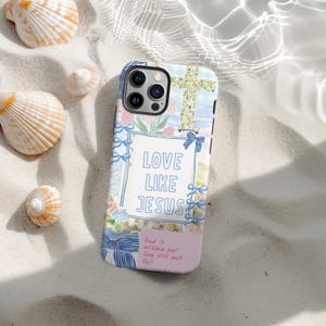 May include: A phone case with a floral and cross design, featuring the text "LOVE LIKE JESUS." The case has a light blue frame with blue bows and the quote "God is within her. She will not fall."