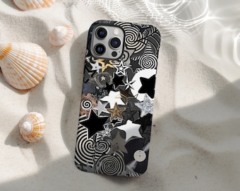 May include: A smartphone case featuring a black, white, and grey star and spiral design. The case is on a sandy surface with seashells. The case has a multi-camera system.