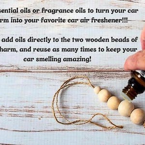 May include: A car air freshener charm made of natural wooden beads strung on twine. The image shows essential oil being added to the beads. Text on the image reads: "Use essential oils or fragrance oils to turn your car charm into your favorite car air freshener!!!"