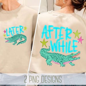 May include: Beige sweatshirt featuring a teal alligator graphic and the word "LATER" on the front. The back of the sweatshirt has the words "AFTER WHILE" and a matching alligator design. The design includes green and pink stars.