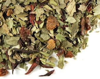 May include: A close-up of a blend of dried herbs and fruit pieces, including green leaves, red hibiscus flowers, and orange fruit pieces. The mixture is likely for making herbal tea.
