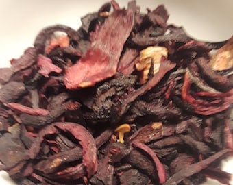 May include: Dried hibiscus flowers, also known as roselle, are a deep red color with some black and brown pieces. The flowers are dried and ready to be used for making tea or other culinary purposes.