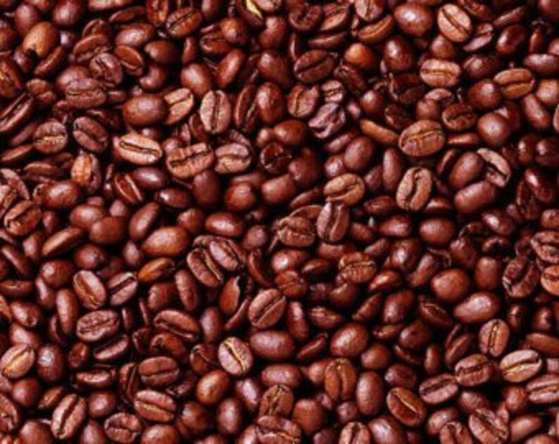 May include: A close-up view of a large quantity of roasted coffee beans. The beans are a rich brown color and have a slightly oily sheen.