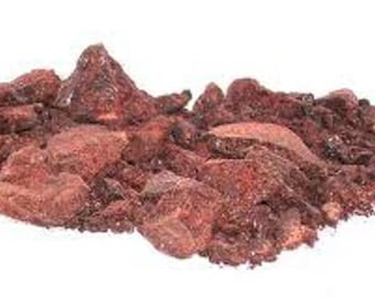 Könnte beinhalten: Ein Haufen loser, dunkelroter, unregelmäßig geformter Harzstücke. Das Harz ist ein Naturprodukt und hat eine raue, strukturierte Oberfläche.