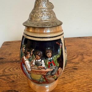 Vintage German Beer Stein with a Pewter Lid and Hand-Painted Scene.