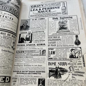 May include: A double-page spread from an old copy of 'The Cosmopolitan' magazine, filled with advertisements. The ads promote education in various fields. The paper is aged, offering a look into the past.
