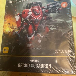 May include: A packaged JOYTOY Infinity action figure of a red and white Gecko Squadron mech. The box features the text "NOMADS" and "GECKO SQUADRON". The scale is 1/18. The figure is designed with intricate details and a futuristic aesthetic.