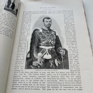 May include: A black and white image of Nicholas II, the Czar of Russia, in a formal military uniform. The image is on a page from a book with English text. The page has aged and yellowed.
