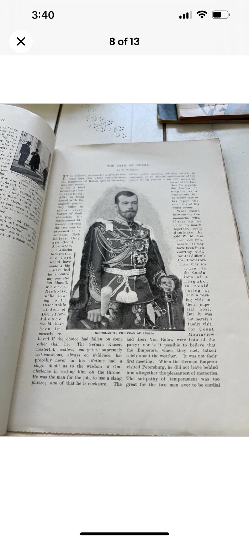 May include: A black and white image of Nicholas II, the Czar of Russia, in a formal military uniform. The image is on a page from a book with English text. The page has aged and yellowed.