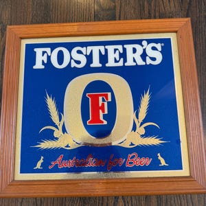 A framed promotional mirror for Foster's Australian Lager.