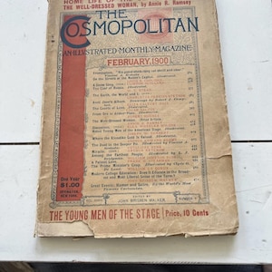 May include: A well-worn February 1900 edition of The Cosmopolitan magazine. The cover displays the magazine's title in red and cream, along with the issue's details. The magazine shows signs of age and use.