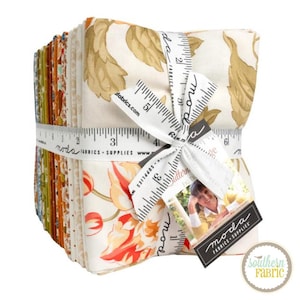 May include: A stack of folded fabric squares tied with a white ribbon printed with a black measuring tape design. The fabric features various autumn-themed patterns in shades of orange, yellow, cream, and brown. A tag with the text Moda Fabrics Supplies.