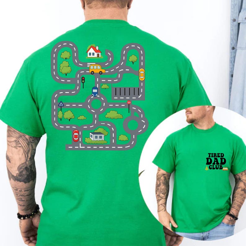 May include: A bright green t-shirt featuring a road map design with cars, houses, and trees. The shirt also has the text "TIRED DAD CLUB" on the front. The design is printed on a green t-shirt.