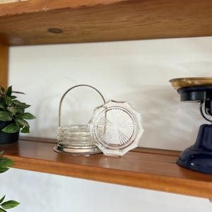 Vintage set of crystal coasters in silver holder