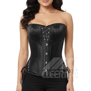 May include: Black strapless corset with vertical paneling and a lace-up front. The corset features a satin finish and is designed with a structured bodice. The garment has a classic silhouette and is suitable for various occasions.