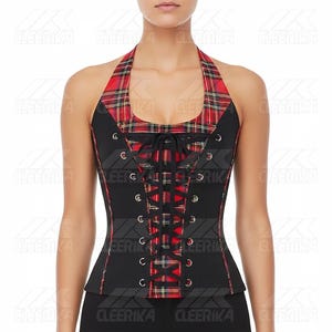 May include: Black halter top corset with red and black tartan detailing. The corset has a lace-up front and a tartan halter neckline. It features silver eyelets and a fitted shape, offering a structured and fashionable appearance.