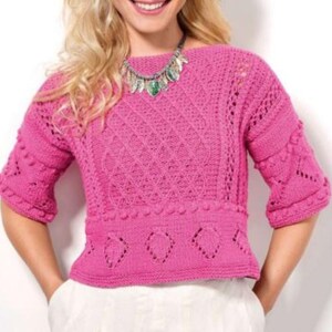 May include: A bright pink, short-sleeved, knitted sweater with a textured pattern. The sweater features a boat neck and a fitted waist with decorative cutouts. The sleeves have a unique design, and the overall style is feminine and handcrafted.