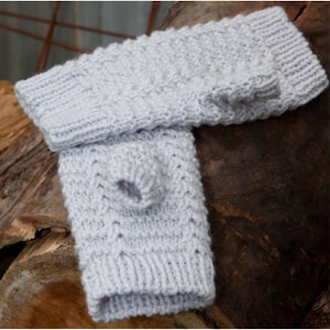 May include: A pair of light gray knitted fingerless gloves. The gloves have a textured cable knit pattern and a thumb hole. The gloves are made of a soft, warm material, perfect for keeping hands warm in cold weather.