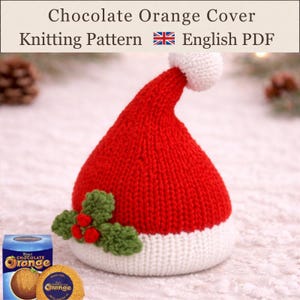 May include: A knitted red and white hat-shaped cover for a chocolate orange, featuring a white pom-pom at the top and a green holly leaf and red berry embellishment. The text reads: Chocolate Orange Cover Knitting Pattern English PDF.