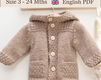 May include: A beige knit baby hooded jacket with long sleeves, a hood, and five light-colored buttons down the front. The jacket features two front pockets and textured knit detailing on the cuffs and pockets. Text reads: Baby Hooded Jacket Pattern Size 3 - 24 Mths English PDF.