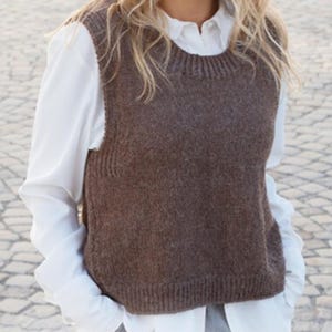 May include: A brown knitted sleeveless sweater vest with a round neckline.