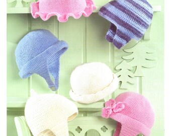 May include: A selection of hand-crocheted hats in shades of pink, blue, and white. Some hats have ear flaps, while others are adorned with details like ruffles and flowers. The hats are presented against a light green backdrop.