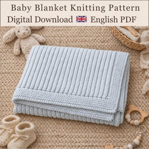 May include: A light blue knitted baby blanket with a ribbed centre and garter stitch border. The text reads Baby Blanket Knitting Pattern Digital Download English PDF. A beige plush toy, two knitted booties, and a wooden teething ring are present.