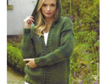 May include: A green hooded sweater with a zipper closure. The sweater is knitted with a textured pattern and has a relaxed fit. The model is wearing a white shirt underneath and white pants.