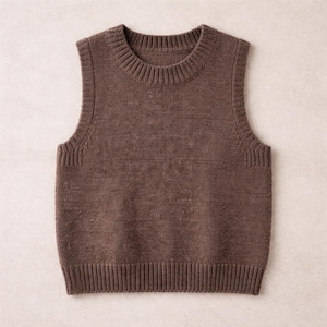May include: A brown knitted vest with a ribbed crew neck, armholes, and hem. The sleeveless sweater is made of a soft, textured material. This versatile garment can be worn as a layering piece.