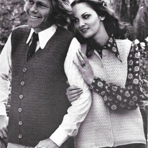 May include: A black and white photograph of a man and a woman. The man wears a dark vest over a white shirt and tie. The woman wears a white cardigan over a patterned blouse. The image is a vintage fashion portrait.