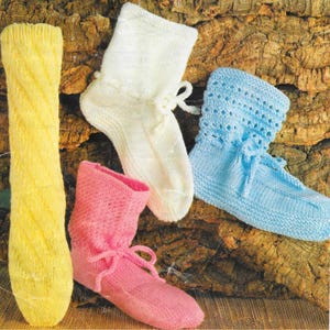 May include: A collection of hand-knitted socks in various colors. The socks include a long yellow sock with a diagonal pattern, a pair of cream-colored socks with a bow, a pair of light blue socks, and a pair of pink socks with a bow.