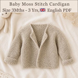 May include: A beige knitted baby cardigan with a moss stitch texture, long sleeves with folded cuffs, and an open front. The text above reads: Baby Moss Stitch Cardigan Size 3Mths - 3 Yrs, English PDF. The garment is displayed on a soft fabric.
