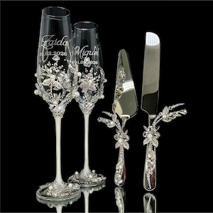 4 piece silver wedding gift set with crystal and pearl jeweled champagne flutes, cake knife and server.