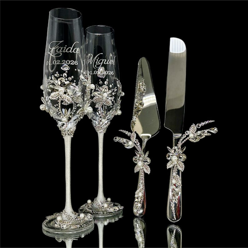 4 piece silver wedding gift set with crystal and pearl jeweled champagne flutes, cake knife and server.
