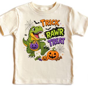 Cute Halloween dinosaur design featuring a smiling T-Rex carrying candy, Trick Rawr Treat lettering, jack-o-lantern pumpkins, bats, spiderwebs, and wrapped sweets.