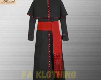 May include: A black cassock featuring a mandarin collar, long sleeves, and a shoulder cape. The garment is accented with red piping along the edges and a vertical row of red buttons. A wide red sash with a fringed end is worn around the waist.