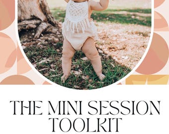 May include: A white and beige baby outfit with a crocheted top and a white headband. The baby is being held by two hands, one on each side, in a grassy outdoor setting.