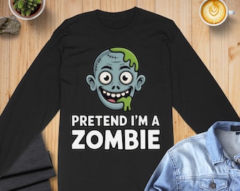 May include: Black long-sleeve shirt with a cartoon zombie face graphic. The zombie has stitches, green slime, and the text "PRETEND I'M A ZOMBIE" in white. Perfect for Halloween or costume parties.