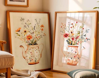 May include: Two framed prints of watercolor paintings featuring floral arrangements in vintage teapots. The teapots are decorated with white and pink polka dots. The flowers are a mix of pink, orange, and yellow.