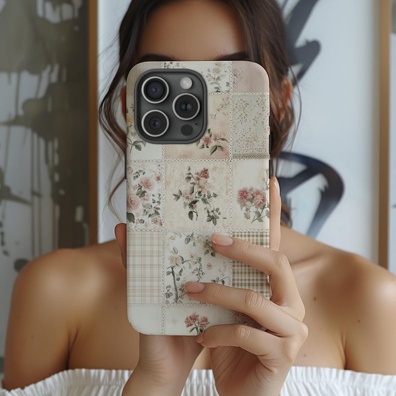 May include: A white iPhone case with a floral patchwork design. The case has a camera lens cutout and a white background.