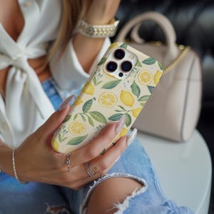 Lemon collage phone case featuring vibrant citrus fruit tropical style design, perfect phone cover for iPhone 16, iPhone 15, iPhone 14, iPhone 13, and iPhone Pro Max. Compatible with Samsung Galaxy S23 S24 S25 Ultra and Google Pixel 8 9 Pro. This tough case offers durable protection with a fresh, colorful look. Ideal gift for her, combining fun summer vibes and reliable phone case protection. Stylish and protective phone cover for fruit and tropical art lovers.