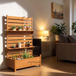 May include: A vertical wooden plant stand with a slatted back panel, two horizontal shelves, and a deep rectangular planter base. The unit features light brown wood grain and holds various small potted succulents and cacti. Text reads GilgitBazaar.
