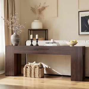 May include: A rustic wooden sign with the text "Welcome to our home" in white lettering. The sign features a distressed finish and a simple, inviting design, perfect for entryway decor.