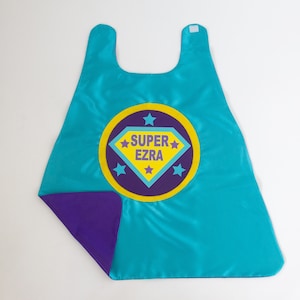 GIRLS FULL NAME Custom Shield Cape / Personalized Superhero Cape / Add Matching Accessories / Superhero Party / Fast Shipping / Halloween 2 TURQU/PURPLE CAPE