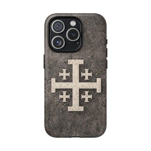 May include: A smartphone case with a textured, gray background. The case features a large, off-white Jerusalem cross design in the center. The phone's camera lenses are visible at the top.