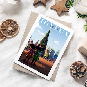 Disneyland Paris Joyeux Noel Illustrated Town Square Christmas Card Design with Mickey & Minnie Mouse admiring the Christmas tree.